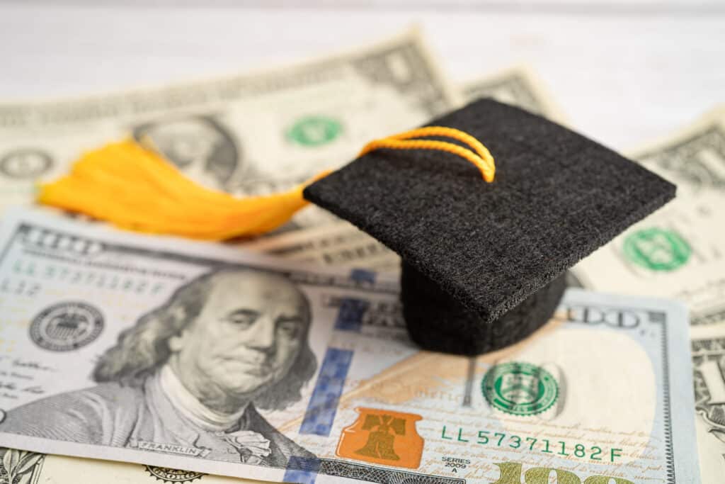 Graduation gap hat on US dollar banknotes money, Education study